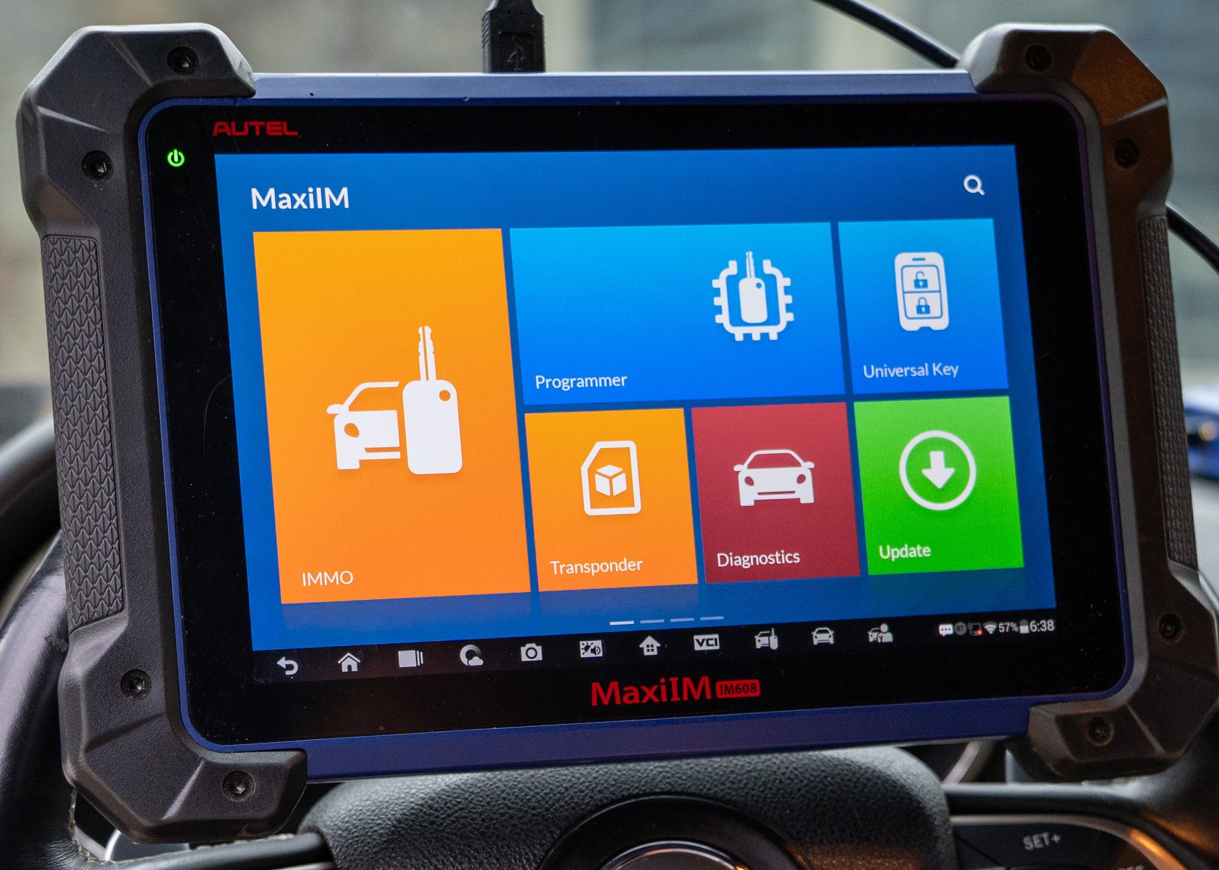 A key-programming tablet with its menu open on screen.